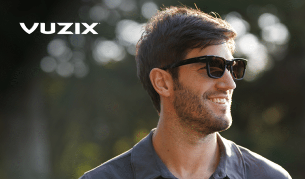 Vuzix Z100 smart glasses worn by a man outside